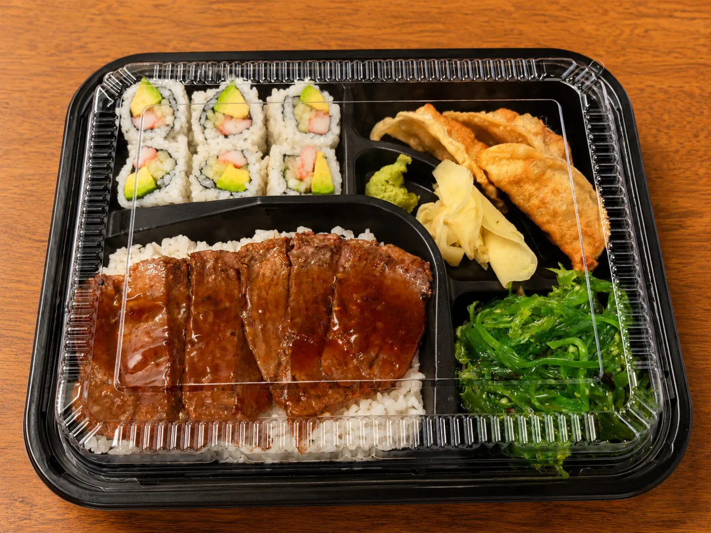 Beef bento with sushi dumpling rice and seaweed salad at China King, an Asian Restaurant in Merritt Island