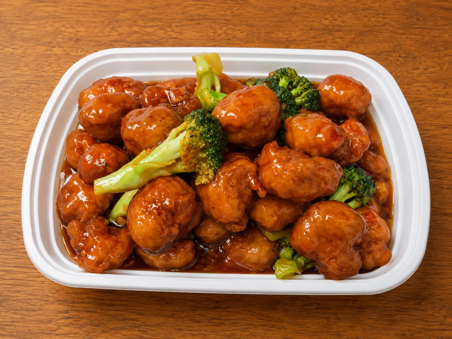 Glazed chicken with broccoli in a takeout tray at China King, an Asian Restaurant in Merritt Island